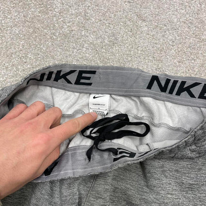 Y2K Nike loose sweatpants joggers grey Swoosh logo fleece lined gym drawstring track pants