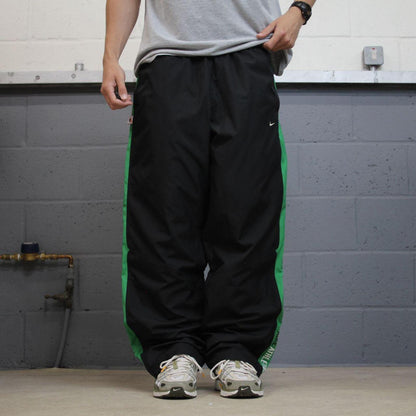 Vintage baggy Nike tracksuit bottoms black Wide leg mesh lined embroidered side stripe track pants