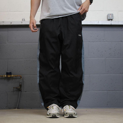 FILA tracksuit bottoms loose leg black Vintage lined embroidered side stripe track pants