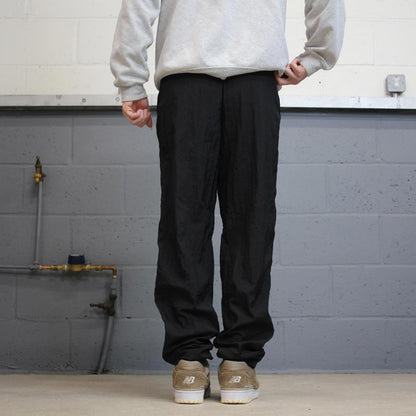 Vintage Nike tracksuit bottoms y2k black medium floaty leg unlined swoosh logo gym wear track pants