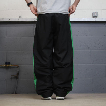 Vintage baggy Nike tracksuit bottoms black Wide leg mesh lined embroidered side stripe track pants