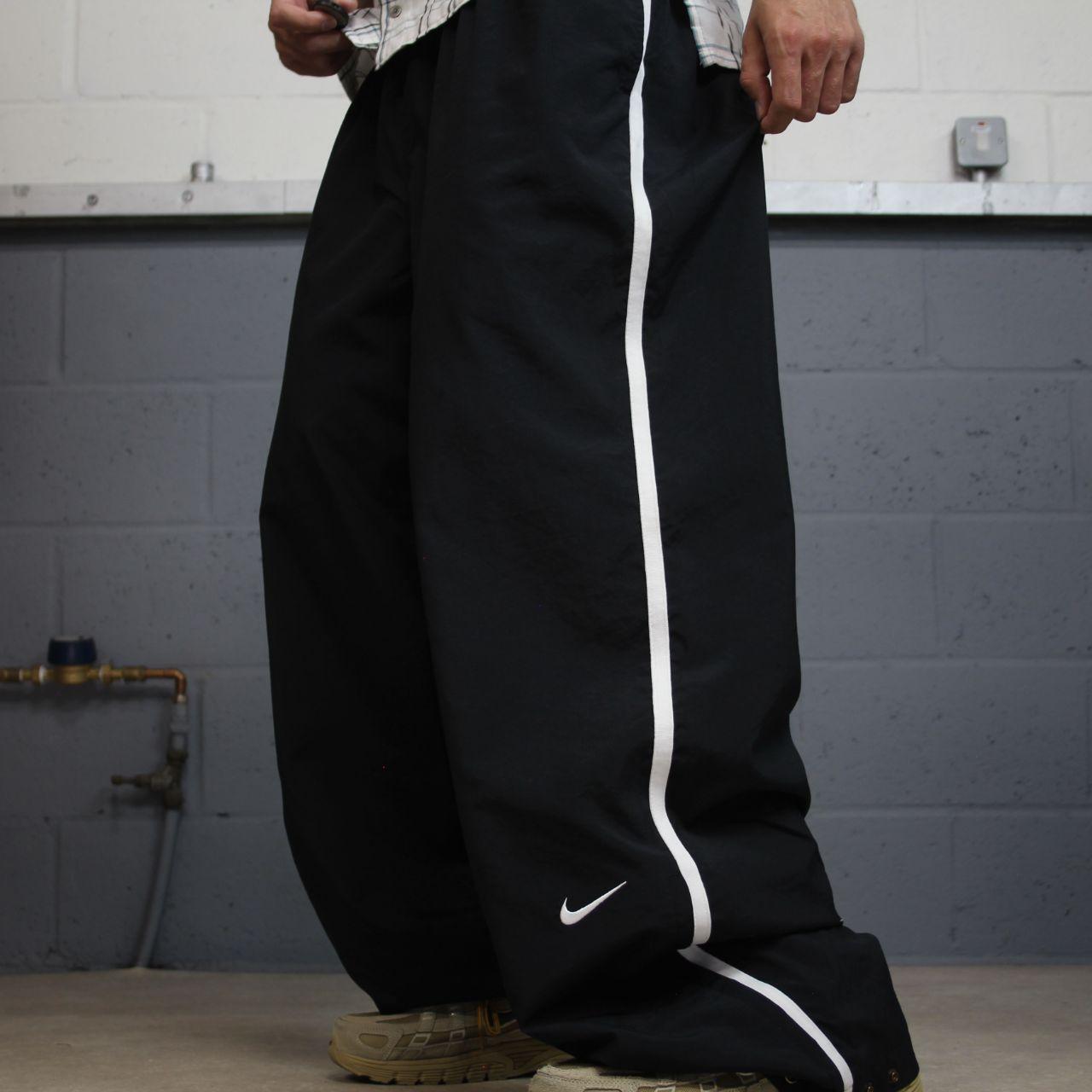 Nike extra baggy tracksuit bottoms wide leg black Nike Team lined embroidered stripe track pants