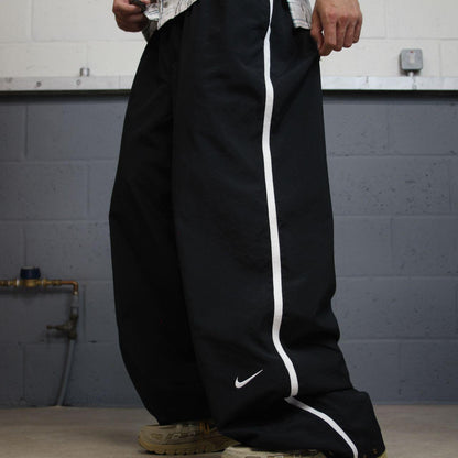Nike extra baggy tracksuit bottoms wide leg black Nike Team lined embroidered stripe track pants