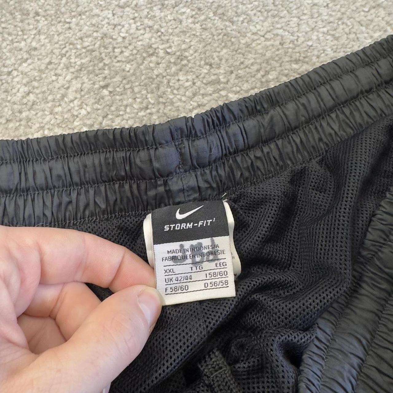 Nike baggy tracksuit bottoms wide leg charcoal Storm-Fit lined embroidered cuffable track pants