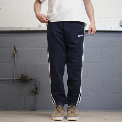 Vintage navy Adidas joggers M y2k style sportswear track pants side stripe design