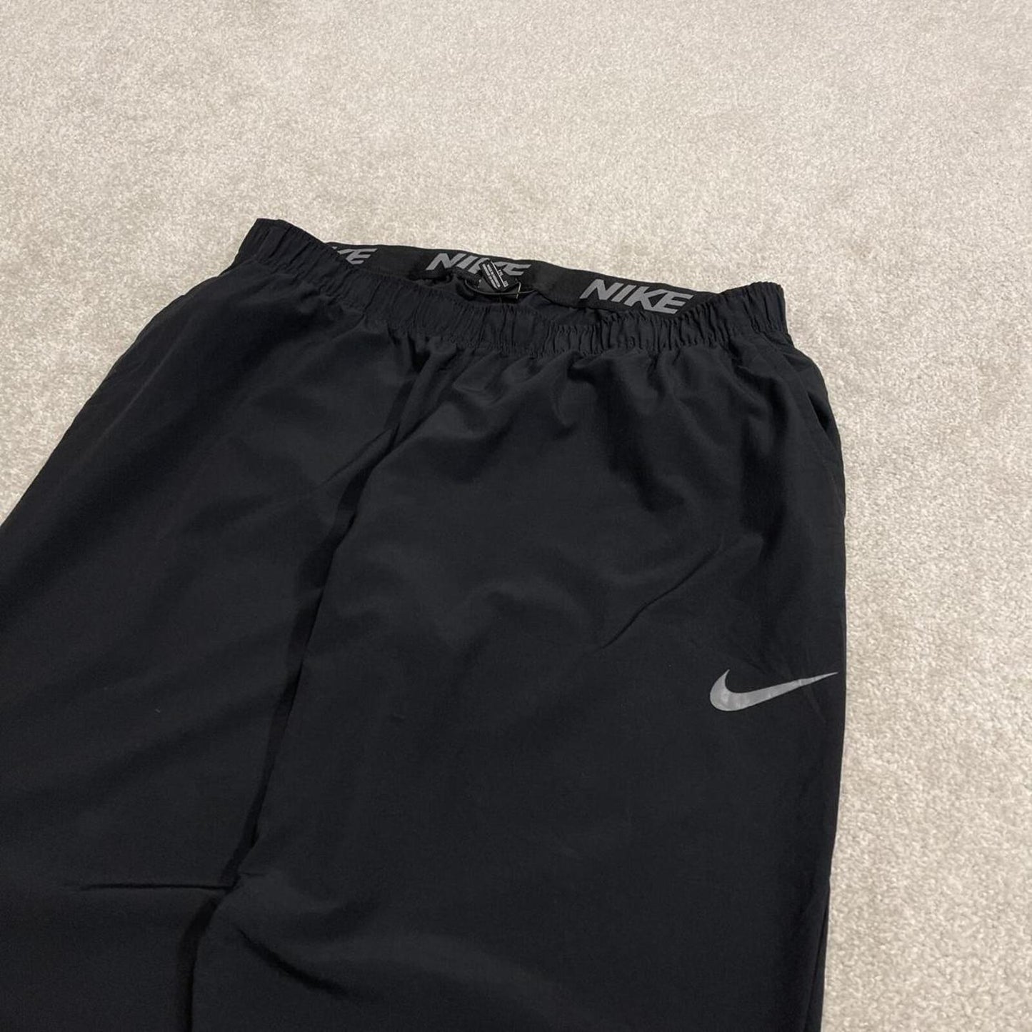 Nike tracksuit bottoms loose fit black Lightweight floaty swoosh logo track pants