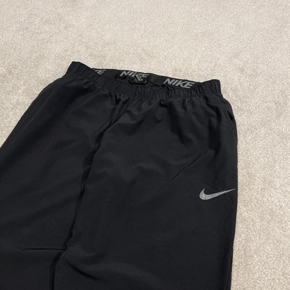 Nike tracksuit bottoms loose fit black Lightweight floaty swoosh logo track pants