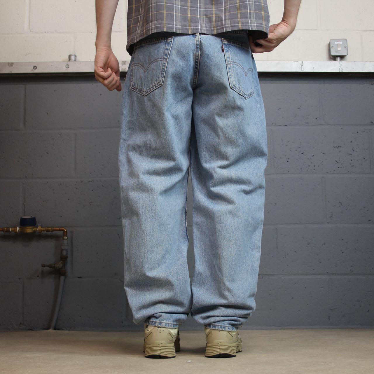 Vintage Levi’s baggy jeans y2k W34L32 washed blue Levi’s 550 relaxed fit surf style pants red tab