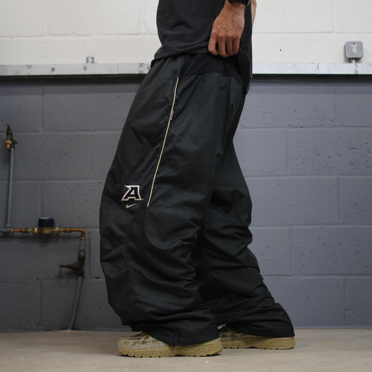 Nike baggy tracksuit bottoms wide leg charcoal Storm-Fit lined embroidered cuffable track pants