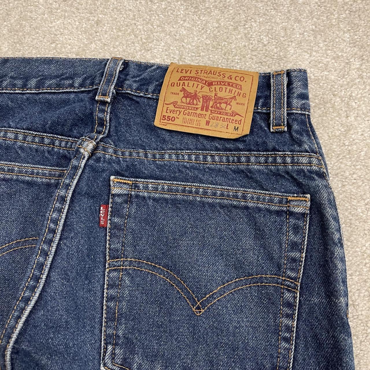 Y2K vintage Levi’s 550 jeans W26L31 blue Relaxed fit tapered leg 5 pocket pants red tab logo