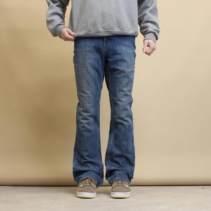 Blue Carhartt jeans size 12 (W34) traditional fit bootcut denim jeans patch logo