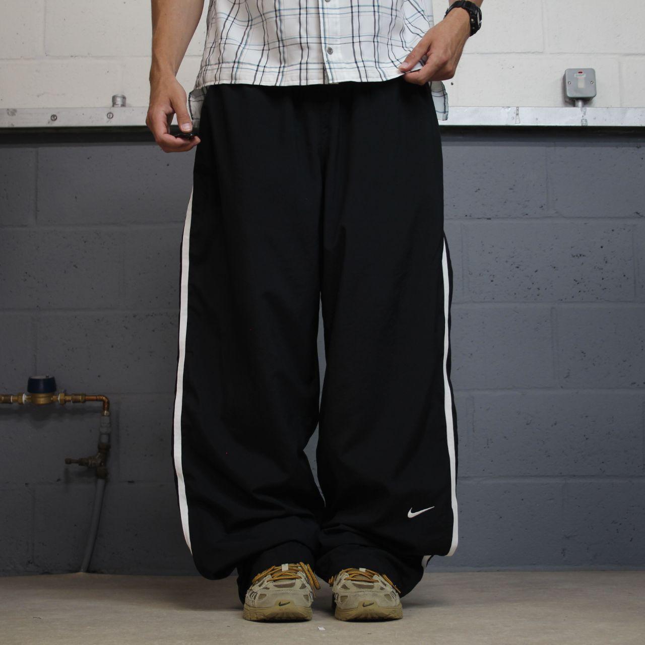 Nike extra baggy tracksuit bottoms wide leg black Nike Team lined embroidered stripe track pants