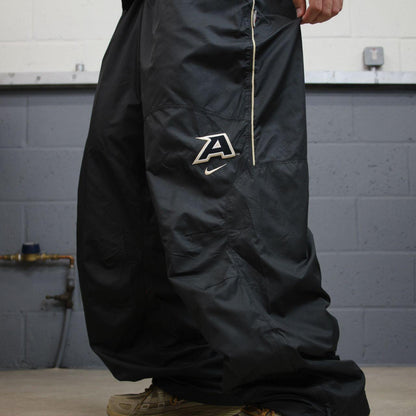 Nike baggy tracksuit bottoms wide leg charcoal Storm-Fit lined embroidered cuffable track pants