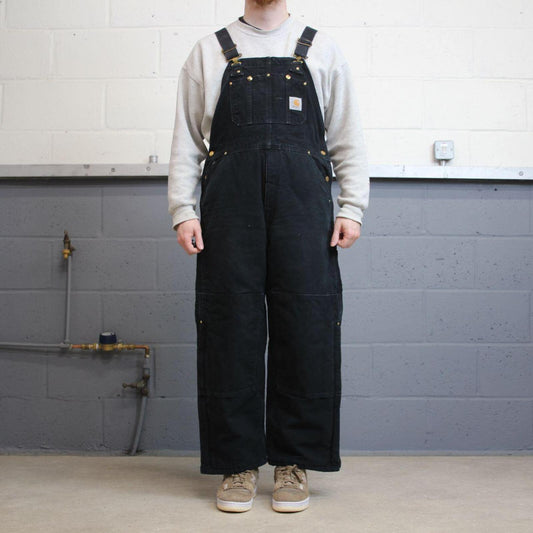 Vintage y2k Carhartt dungarees loose leg faded black Canvas quilt lined bib & brace overalls