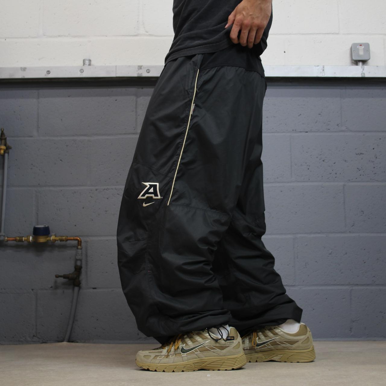 Nike baggy tracksuit bottoms wide leg charcoal Storm-Fit lined embroidered cuffable track pants