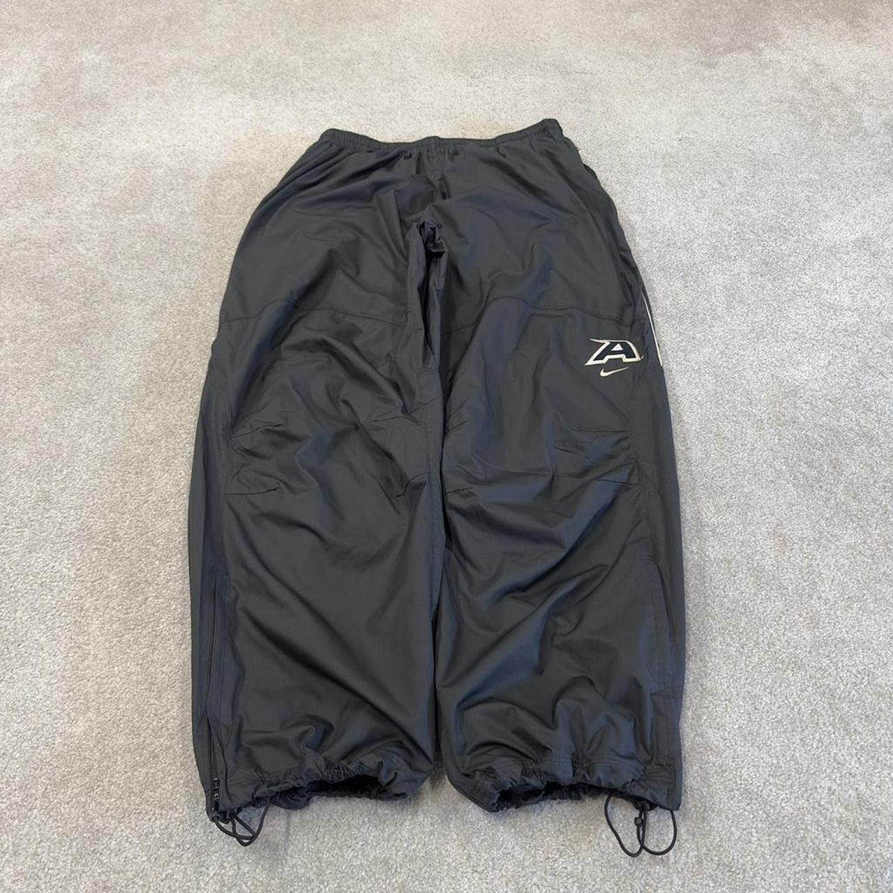 Nike baggy tracksuit bottoms wide leg charcoal Storm-Fit lined embroidered cuffable track pants