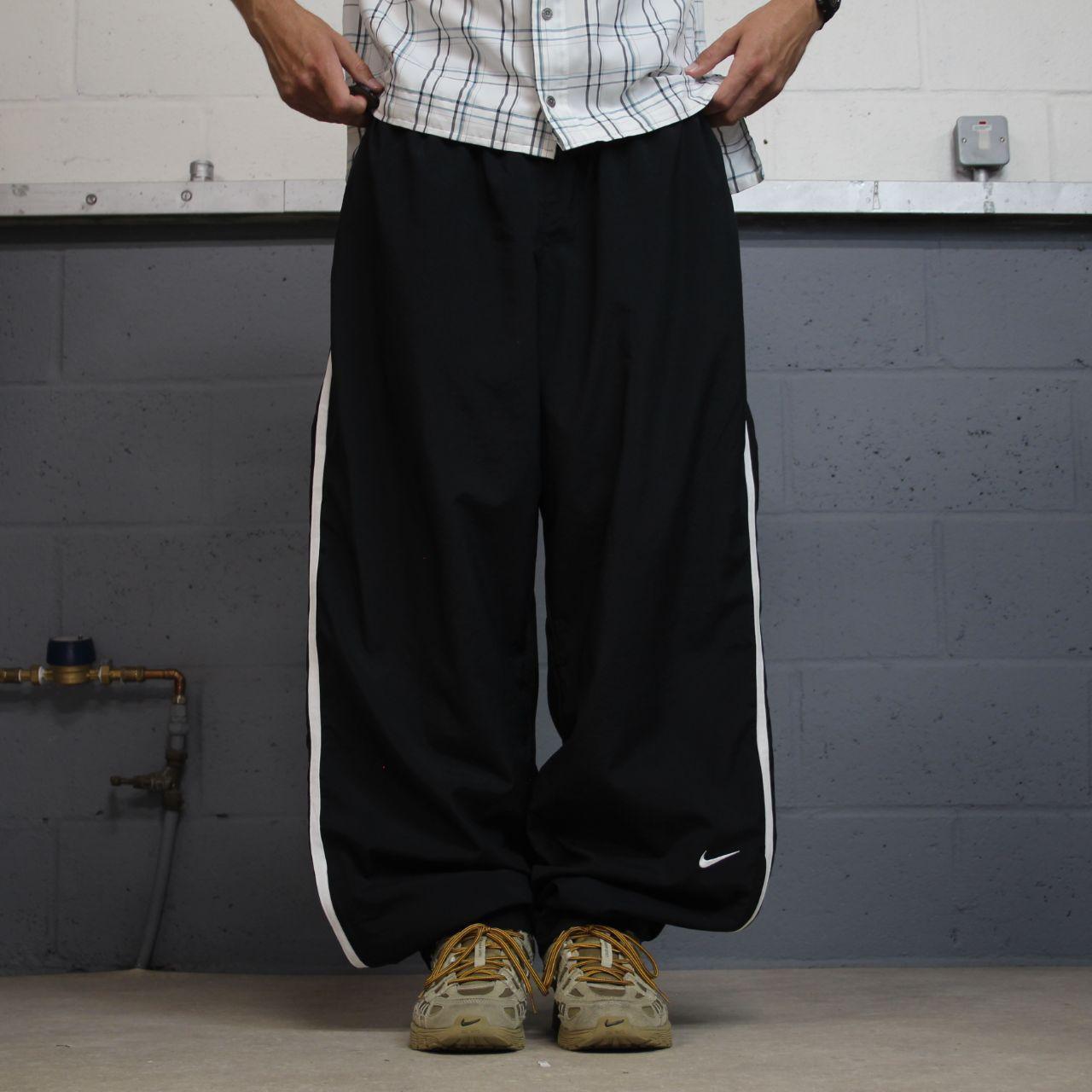 Nike extra baggy tracksuit bottoms wide leg black Nike Team lined embroidered stripe track pants