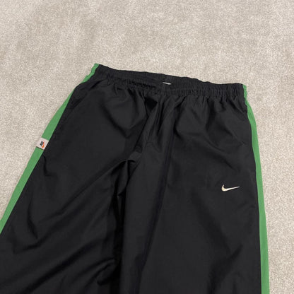 Vintage baggy Nike tracksuit bottoms black Wide leg mesh lined embroidered side stripe track pants
