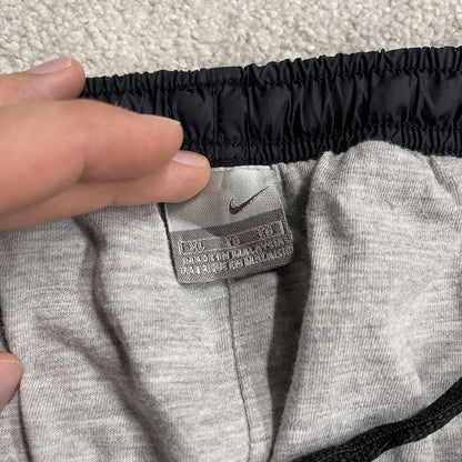 Vintage Nike baggy tracksuit bottoms Y2K black Wide leg lined embroidered side stripe track pants