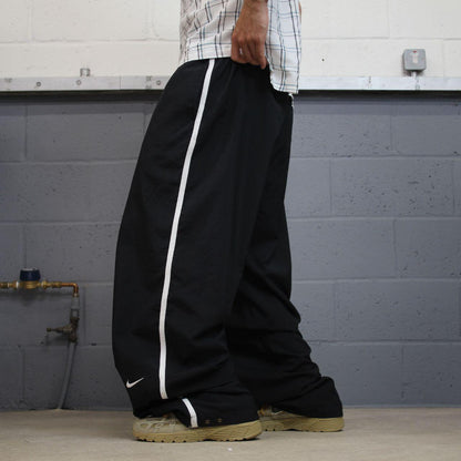 Nike extra baggy tracksuit bottoms wide leg black Nike Team lined embroidered stripe track pants