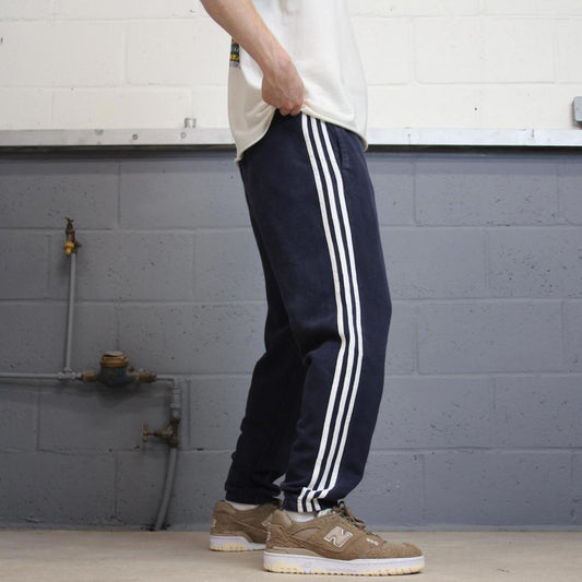Vintage navy Adidas joggers M y2k style sportswear track pants side stripe design