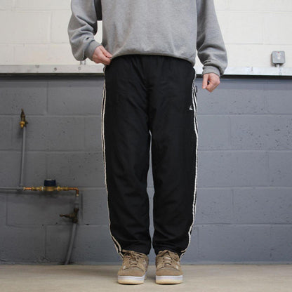 Vintage Y2K Adidas tracksuit bottoms black Loose leg mesh lined side stripe track pants