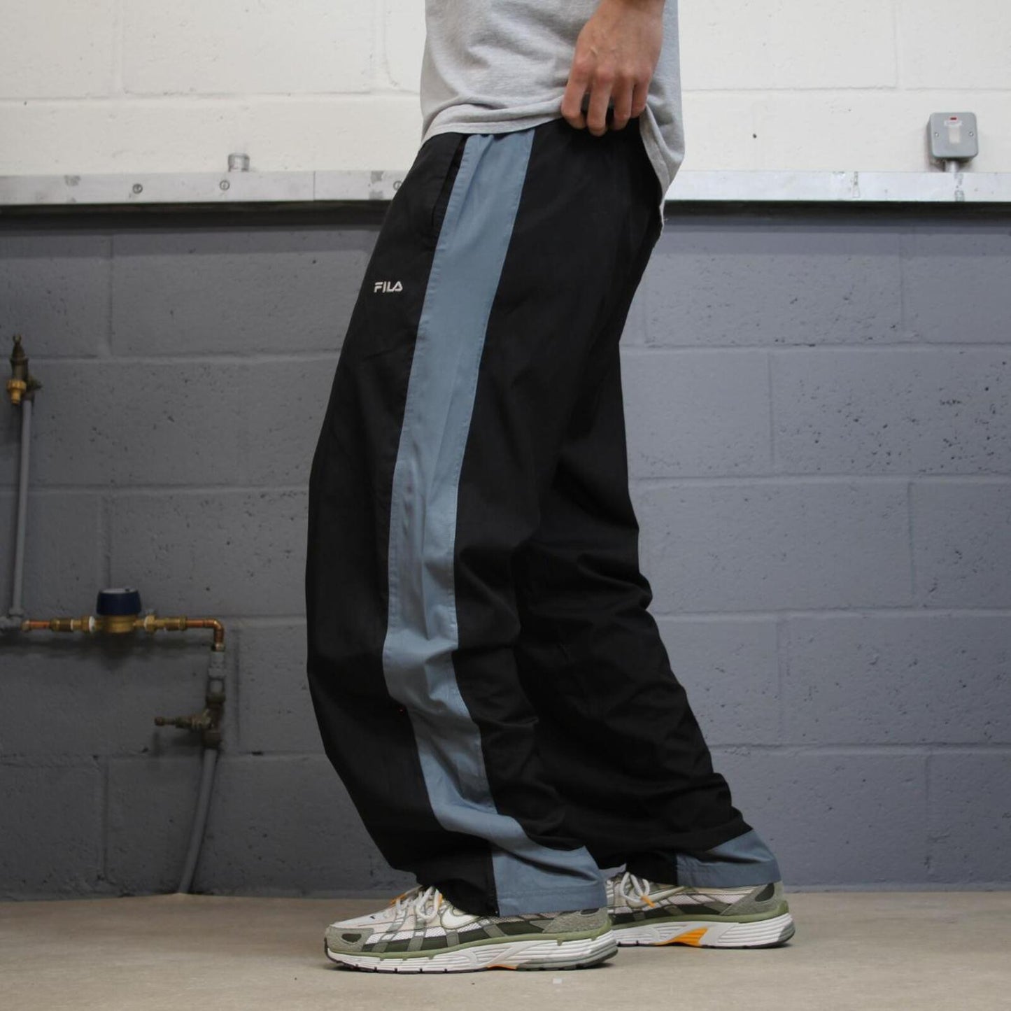FILA tracksuit bottoms loose leg black Vintage lined embroidered side stripe track pants