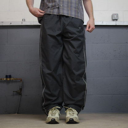 Vintage Nike baggy tracksuit bottoms Y2K grey Wide leg lined embroidered side stripe track pants