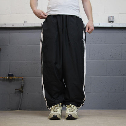Vintage Adidas tracksuit bottoms loose black Loose floaty embroidered side stripe track pants
