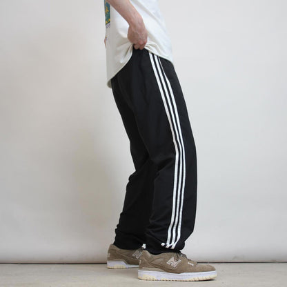 Adidas Trackies L black y2k track bottoms embroidered logo side stripe design
