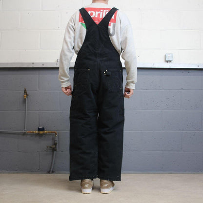 Vintage y2k Carhartt dungarees loose leg faded black Canvas quilt lined bib & brace overalls
