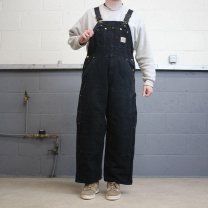 Vintage y2k Carhartt dungarees loose leg faded black Canvas quilt lined bib & brace overalls