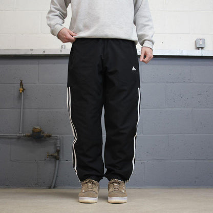 Black Adidas trackies Large y2k loose style sportswear track pants embroidered side stripe design