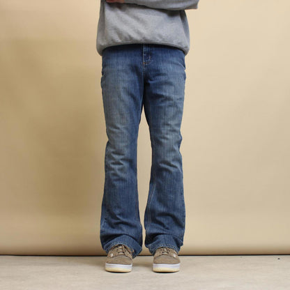 Blue Carhartt jeans size 12 (W34) traditional fit bootcut denim jeans patch logo