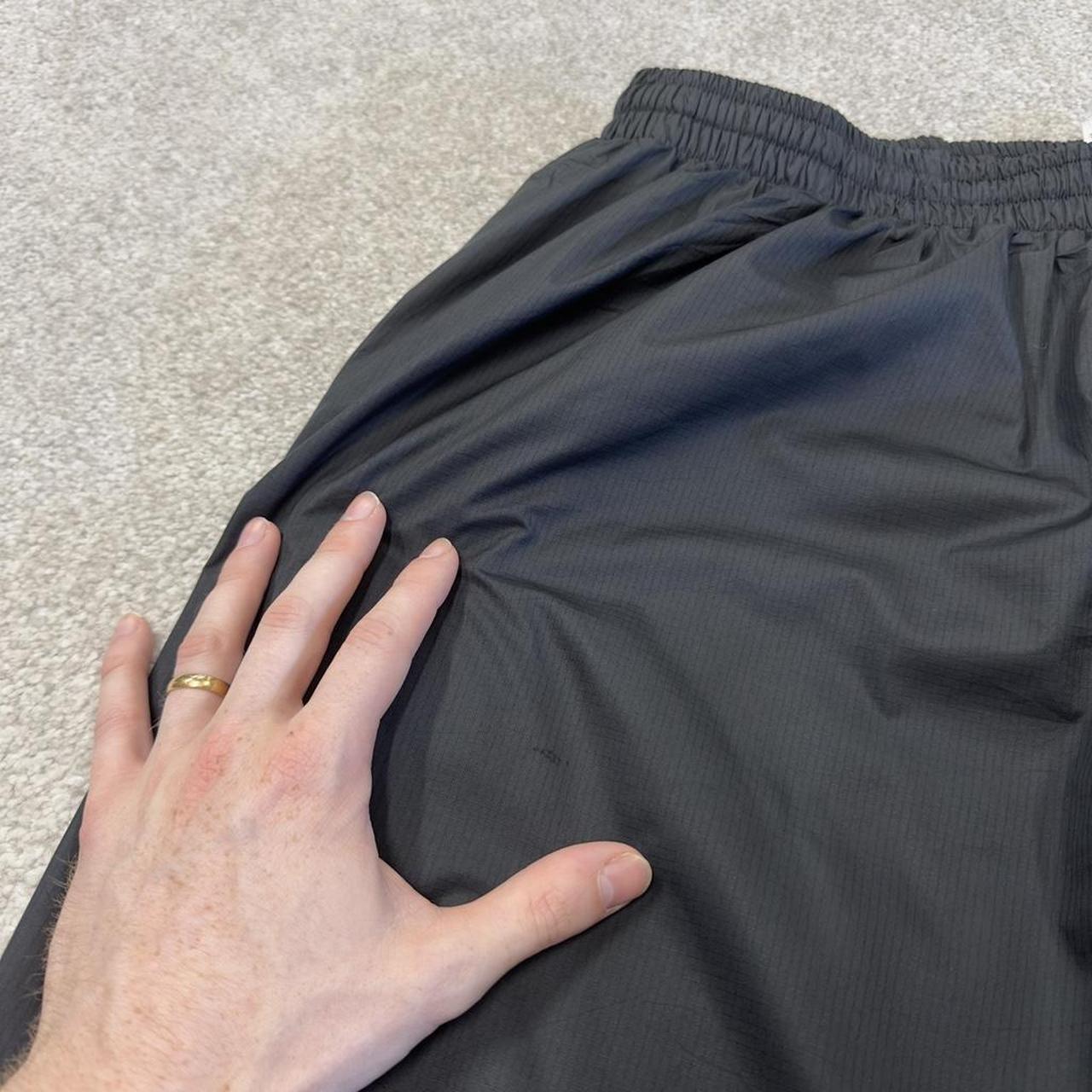 Nike baggy tracksuit bottoms wide leg charcoal Storm-Fit lined embroidered cuffable track pants