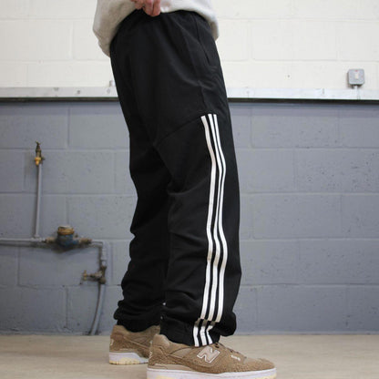 Black Adidas trackies Large y2k loose style sportswear track pants embroidered side stripe design