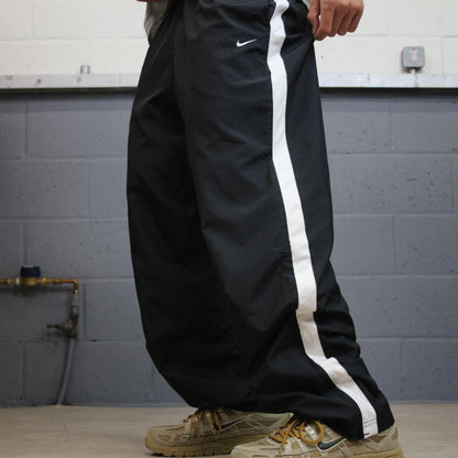 Nike tracksuit bottoms Y2K black Loose fit mesh lined embroidered side stripe track pants