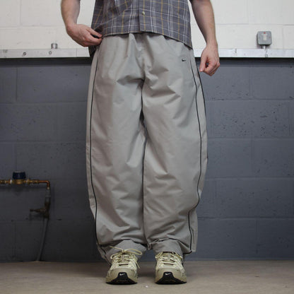Vintage Nike baggy tracksuit bottoms Y2K grey Wide leg lined embroidered side stripe track pants