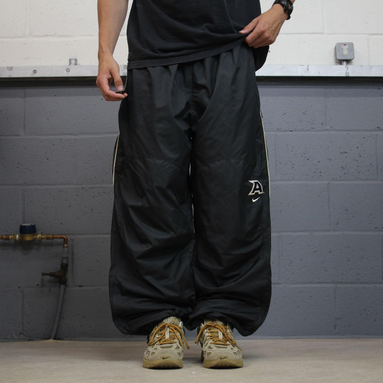Nike baggy tracksuit bottoms wide leg charcoal Storm-Fit lined embroidered cuffable track pants